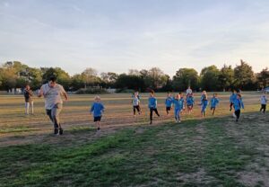 beavers and beaver leader playing at the park