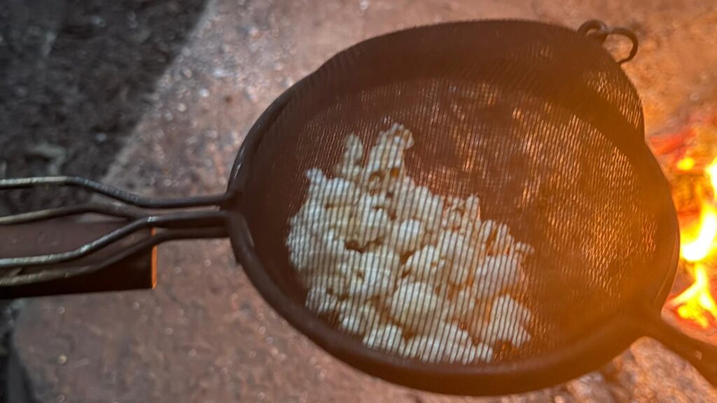 popcorn being cooked in a pan