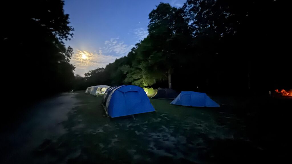 Set of tents in a field at dusk