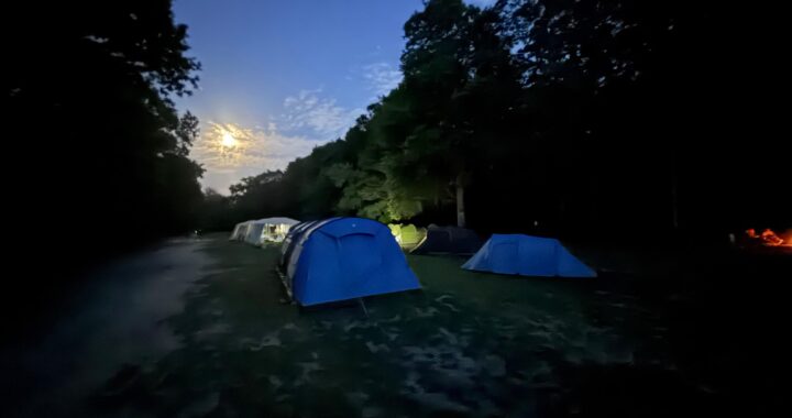 Set of tents in a field at dusk